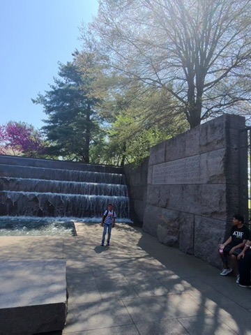 The dramatic waterfall at the FDR Memorial with visitors standing in front